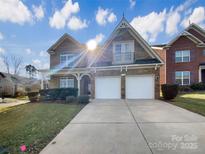 Charming two-story home with a stone and brick facade and well-maintained landscaping at 9503 Rocky Spring Nw Ct, Concord, NC 28027