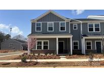 Charming new construction townhome with gray siding and covered front porch, ready for move-in at 114 Ciara Pl # A, Mooresville, NC 28117