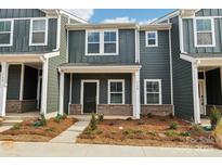 Charming townhome with a welcoming entrance and beautifully landscaped front yard at 114 Ciara Pl # B, Mooresville, NC 28117