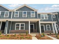 Charming two-story townhome featuring a gray facade with white trim and a welcoming front porch at 114 Ciara Pl # C, Mooresville, NC 28117