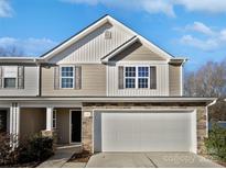 Charming two-story home with a stone-accented facade and a two-car garage at 121 Woodbridge Cir, Mount Holly, NC 28120