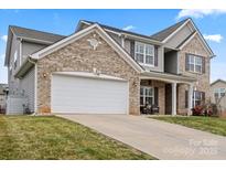 Charming two-story home features a brick and siding exterior and a spacious two-car garage at 806 Irish Green Dr, Clover, SC 29710
