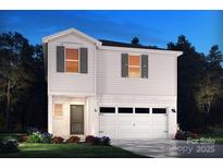 Inviting two-story home featuring white siding, brick accents, and an attached two-car garage at 912 Smithcliffs Trl, York, SC 29745