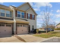 Charming townhome with a two-car garage and classic architectural details at 11142 Jc Murray Nw Dr, Concord, NC 28027
