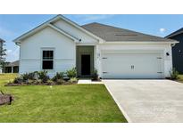 Charming single-story home with a manicured lawn and a two-car garage, providing both curb appeal and practicality at 1418 Windy Park Dr, Stanley, NC 28164