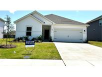 Charming single-story home featuring a well-manicured lawn and attached two-car garage at 1418 Windy Park Dr, Stanley, NC 28164