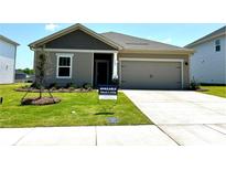 Charming one-story home with a manicured lawn, a two-car garage and neutral-colored siding at 1422 Windy Park Dr, Stanley, NC 28164