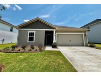 Charming one-story home with a manicured lawn, neat landscaping, and a neutral color palette at 1422 Windy Park Dr, Stanley, NC 28164