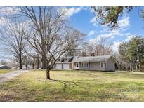 Charming single-story home with a spacious front yard and two-car garage, perfect for suburban living at 15905 Sunset Dr, Huntersville, NC 28078