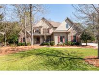 Charming home with stone accents, red shutters, and a well-manicured lawn creating a welcoming curb appeal at 258 Ridge Reserve Dr, Lake Wylie, SC 29710