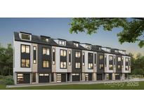 Modern townhome featuring sleek black and white facade, with individual garages and multiple windows at 3202 Riley Ave, Charlotte, NC 28269