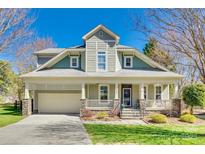Charming two-story home with a welcoming front porch and attached garage, perfect for suburban living at 7817 Crestfield Ln, Tega Cay, SC 29708