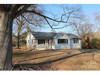 Charming, updated ranch-style home with an inviting front porch and fresh landscaping at 8405 Fairview Rd, Mint Hill, NC 28227