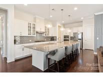 Spacious kitchen with a large island, white cabinetry, stainless steel appliances, and a tile backsplash at 865 Kathy Dianne Dr, Fort Mill, SC 29707