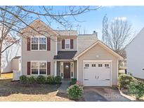 Charming two-story home features a well-maintained lawn, attached garage, and classic architectural details at 1246 Winding Path Rd, Clover, SC 29710