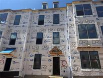 New townhome construction showcasing large windows and modern design elements on a sunny day at 15336 Ballancroft Pkwy # 16, Charlotte, NC 28277