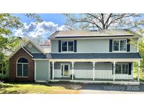 Charming two-story home with solar panels, front porch and black shutters at 1589 E Lakewood Dr, Rock Hill, SC 29732