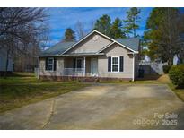 Charming one-story home featuring neutral siding, black shutters, a cozy front porch, and a well-manicured lawn at 1660 Ashridge Rd, Rock Hill, SC 29730