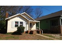 Charming bungalow with a brick foundation, shutters and covered entry; perfect for comfortable living at 3238 Rogers St, Charlotte, NC 28208