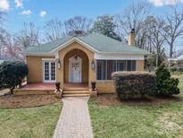 Charming brick home featuring a manicured lawn, covered entryway, and attractive landscaping at 333 7Th Nw St, Hickory, NC 28601