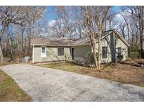 Charming single-story home with a long driveway surrounded by mature trees at 3929 Fernleaf Ct, Charlotte, NC 28215