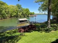 Beautiful lake view featuring a private boat dock and lush green surroundings at 5153 Glenwood St, Sherrills Ford, NC 28673