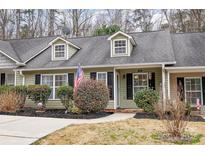 Charming townhome with dormer windows, manicured landscaping, and an inviting entryway at 543 Weavers Xing, Fort Mill, SC 29715