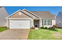 Charming single-story home with a white garage door, inviting front lawn, and well-maintained landscaping at 908 Morien St, Richburg, SC 29729