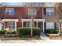 Charming brick townhome exterior featuring a well-maintained front yard and inviting entrance at 915 Tj Dr, Monroe, NC 28112
