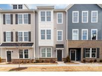 View of townhomes with neutral siding, black door awnings, and manicured front lawns at 110 Wesser St, Davidson, NC 28036