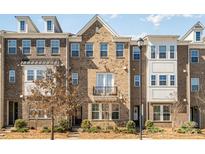 Charming brick townhome featuring a small balcony and well-maintained landscaping at 11537 Red Rust Ln, Charlotte, NC 28277