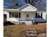 Charming single-story home featuring white siding, black shutters, and a welcoming front porch at 116 Nella St, Chester, SC 29706