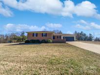 Charming brick ranch home with a well-maintained lawn and attached garage at 125 Newport Dr, Salisbury, NC 28144