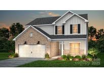Charming two-story home featuring a brick-and-siding exterior, attached two-car garage and manicured front lawn at 1279 Kindness Nw Ct, Concord, NC 28027