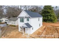 New construction featuring white siding and dark roof with a covered front entryway and attached garage at 162 S Sycamore St, Mooresville, NC 28115