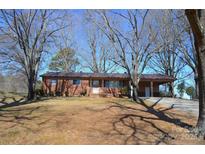 Charming brick home with a carport and mature trees in a quiet neighborhood at 1886 Buffalo Shoals Rd, Statesville, NC 28677