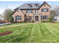 Stately brick home boasts meticulous landscaping, manicured lawn, and classic architectural details at 2432 Westfield Rd, Charlotte, NC 28207