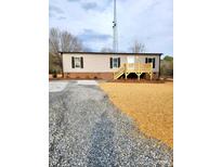 Charming one-story home featuring a spacious gravel driveway and a welcoming wood deck at 2950 Old Cliffside Rd, Shelby, NC 28152