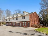 Brick and siding townhouse complex with parking and well-maintained landscaping at 405 Wilson N St, Rock Hill, SC 29730