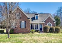 Charming brick home with a manicured lawn, inviting curb appeal and beautiful architectural details at 4103 Belle Meade Cir, Belmont, NC 28012