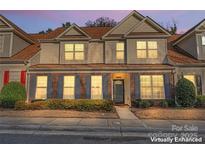 Charming townhome featuring a brick facade, well-maintained landscaping, and a welcoming entrance at 10123 Oxford Landing Ln, Charlotte, NC 28270