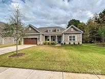 Charming single-story home featuring a well-manicured lawn and inviting facade at 10521 Ardley Manor Dr, Mint Hill, NC 28227