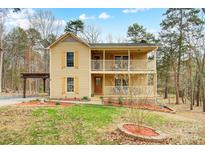 Charming two-story home with a double front porch and well-manicured lawn at 1426 Crescent St, Monroe, NC 28112