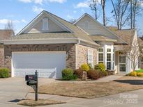 Charming brick home features a two-car garage, well-manicured lawn, and inviting curb appeal at 23072 Whimbrel Cir, Fort Mill, SC 29707