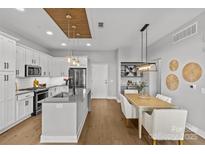 Open concept kitchen and dining area with stainless steel appliances and bright, airy design at 2401 Euclid Ave # 213, Charlotte, NC 28203