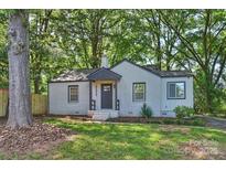 Charming white-painted brick home featuring a cozy covered entryway and well-manicured lawn at 2529 Grimes St, Charlotte, NC 28206