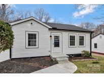 Charming bungalow with freshly painted white siding, black trim, and a neatly landscaped front yard at 345 Grice St, Shelby, NC 28150