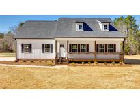 Charming farmhouse with a welcoming front porch and dormer windows at 453 Cedar Grove Rd, Clover, SC 29710