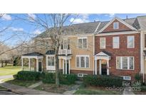 Charming townhomes with landscaped front yards, covered entrances, and a mix of brick and siding facades at 582 Sixth Baxter Xing, Fort Mill, SC 29708