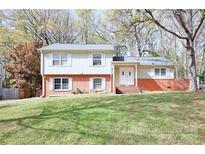 Charming two-story home with brick accents and a well-manicured front lawn at 7515 Riding Trail Rd, Charlotte, NC 28212